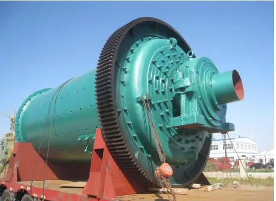 Large green ball mill with a ring gear on a transport trailer